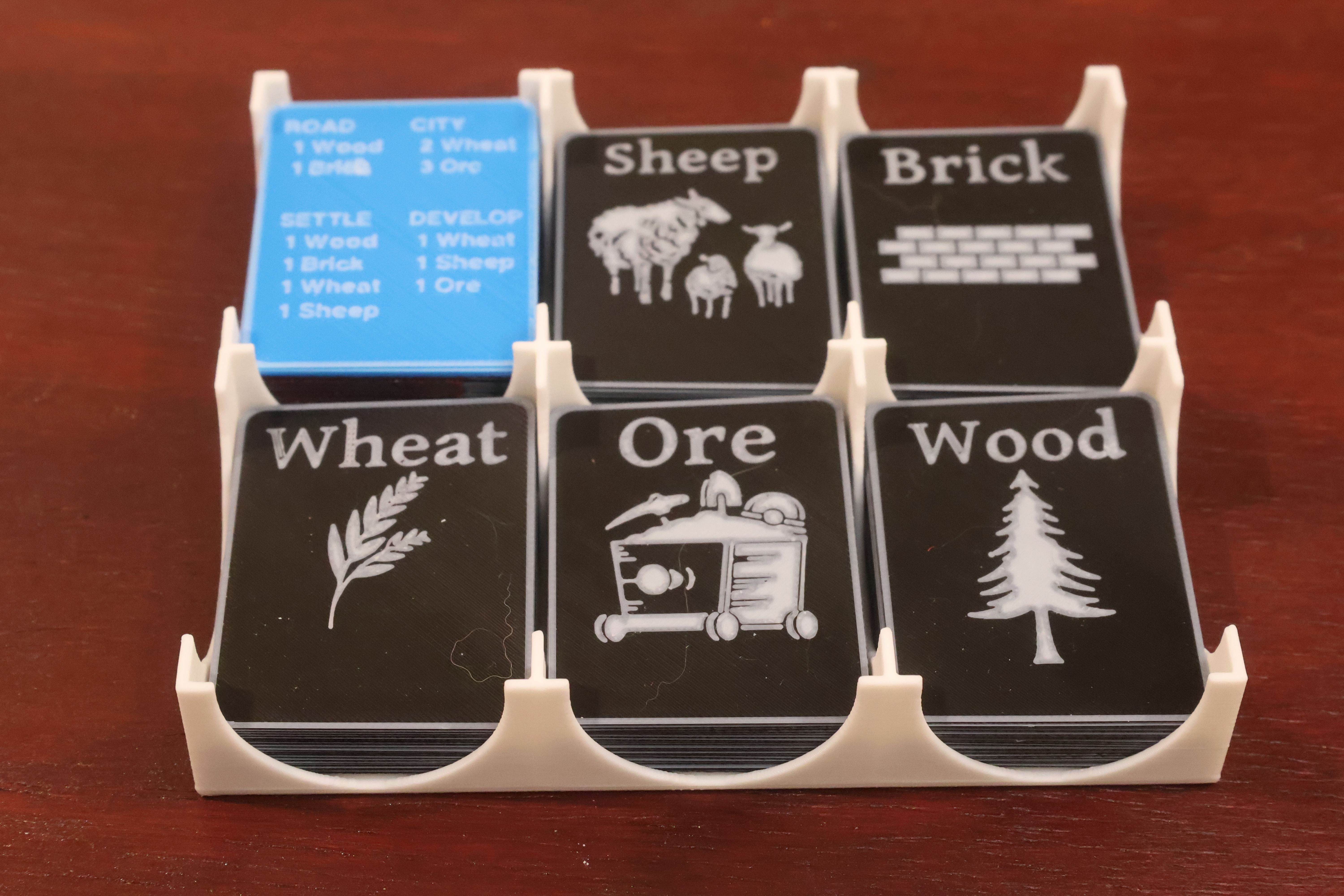 A custom-fitted card tray cradling the resource and development decks