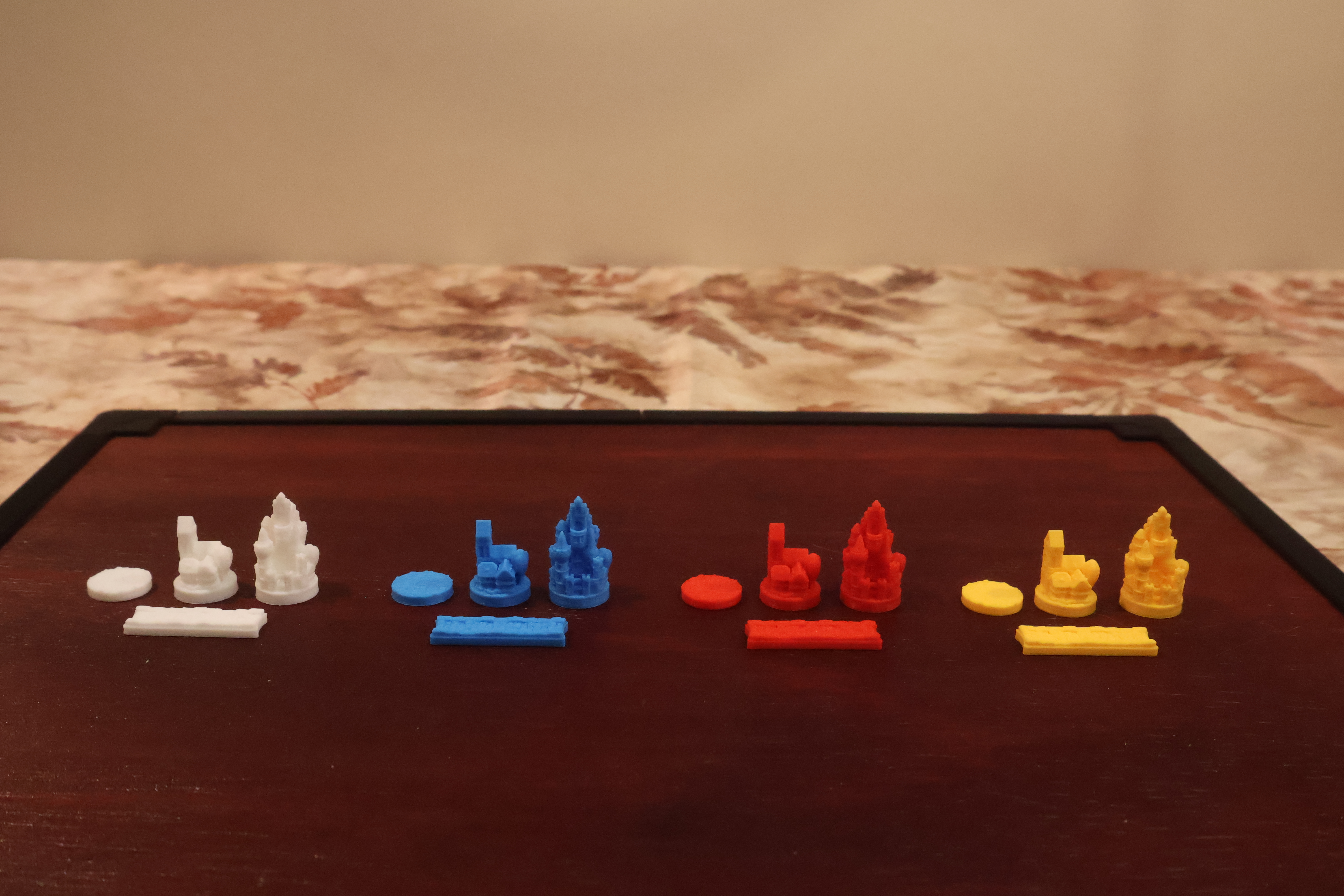 Full set of basic solid-color Catan player pieces — settlements, cities, and roads in all available colors